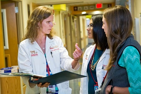 Doctor and residents in a discussion on patient care
