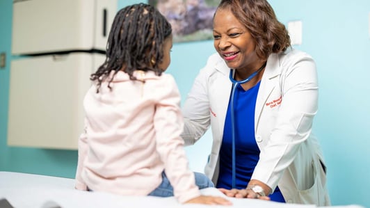 Doctor and child in a exam room.