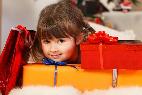 Little girl surrounded by gift boxes