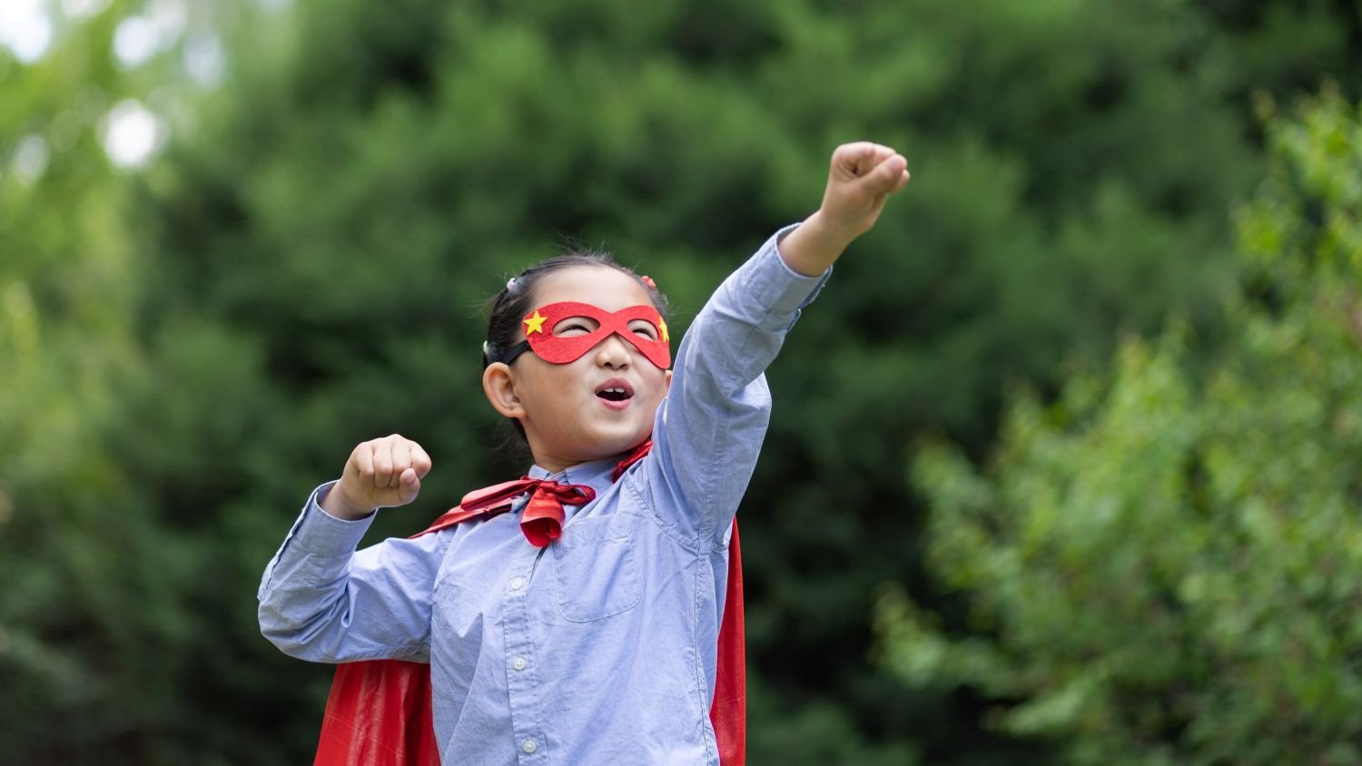 girl dressed up as superhero striking a pose