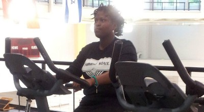 Renesha exercising on a stationary bicycle.