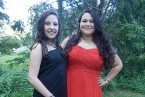 Sabrina and a female friend wearing formal gowns.