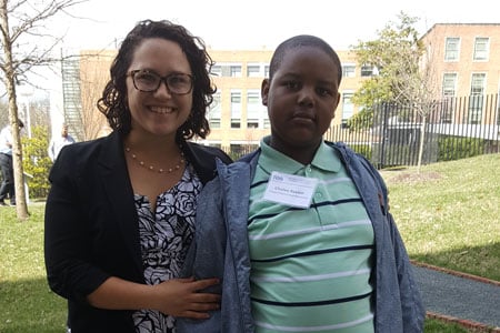 Xavion standing with Dr. Kirkorian, his primary dermatologist at Children's National