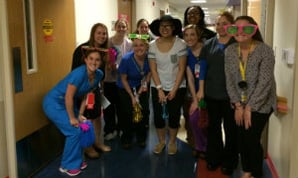 Carly and her Children's care staff smile for camera