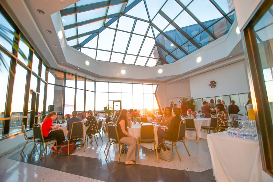 Overall shot of dining area with sunset coming through windows during Advanced Practice Providers event.