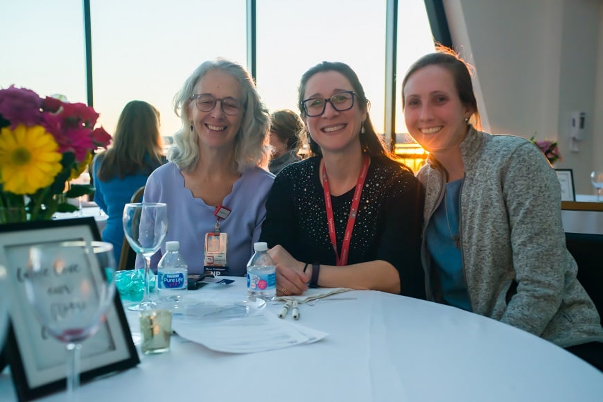 A trio of Advanced Practice Providers sitting at a dining table at the APP dinner.