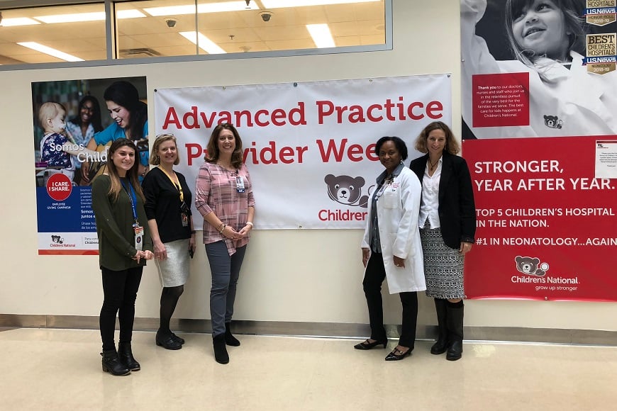 A group of Advanced Practice Providers stand by the APP Week banner at Children's National.