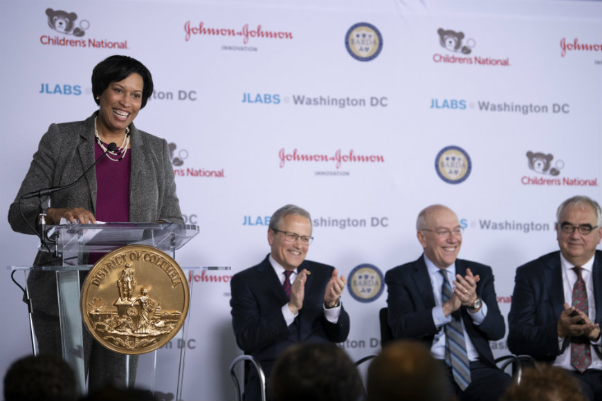 Washington, D.C., Mayor Muriel Bowser laughs and speaks at the podium during press conference.
