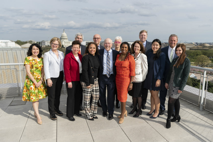 Group of men and women. including CEO and President Kurt Newman, M.D., and VP of Communication, PR and Marketing Kimberly Ovitt pose for a photo on the Newseum rooftop.