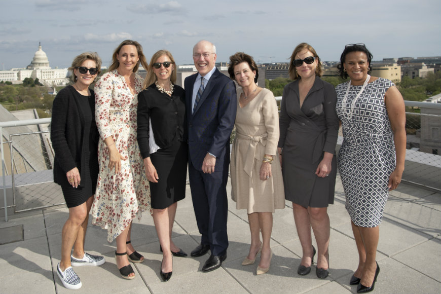 CEO and President Kurt Newman poses with group of female professionals on Newseum rooftop after press conference.