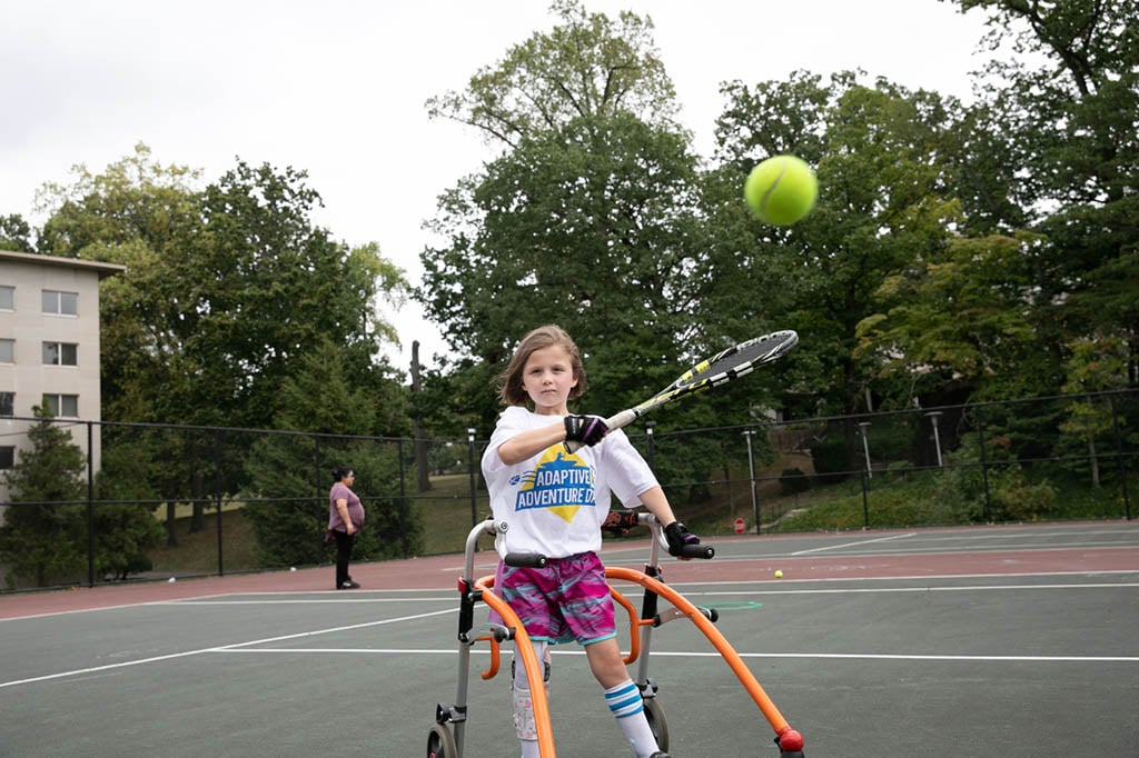 girl playing tennis