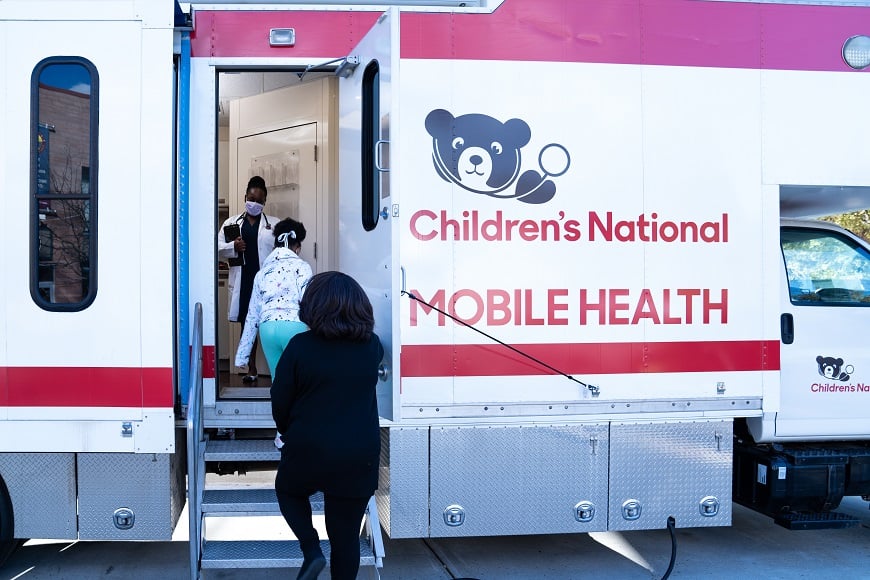 A family enters the mobile health van.