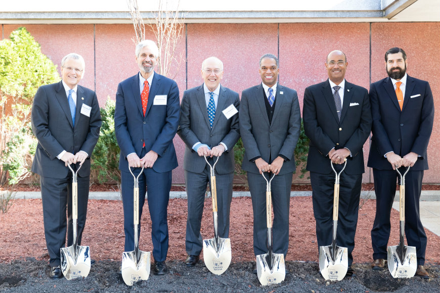 Six male community and Children's National leaders grip shovels as they prep to break ground.