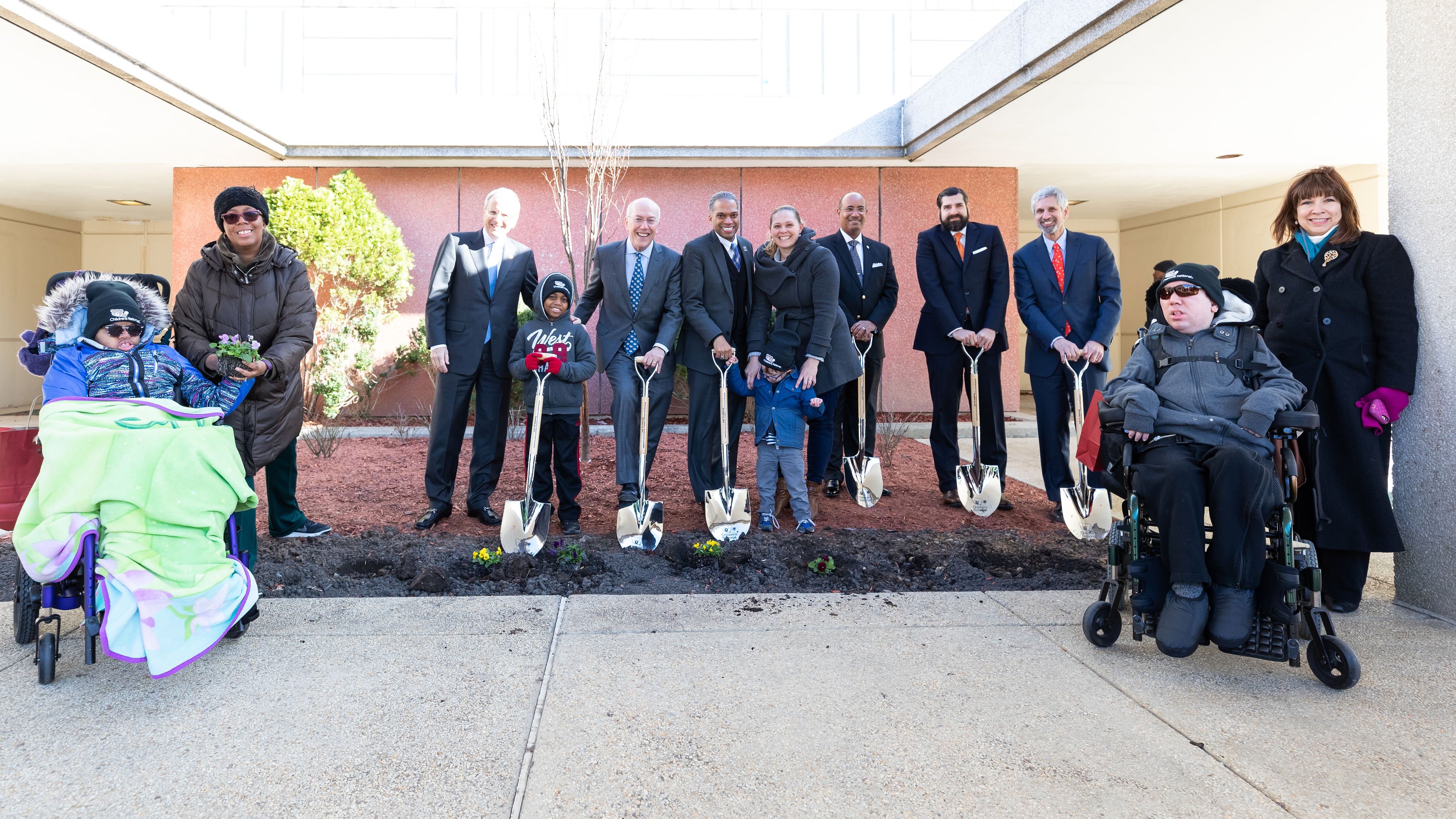 Group photo of pediatric patients, their families, council members and Children's National leaders at historic Walter Reed site.