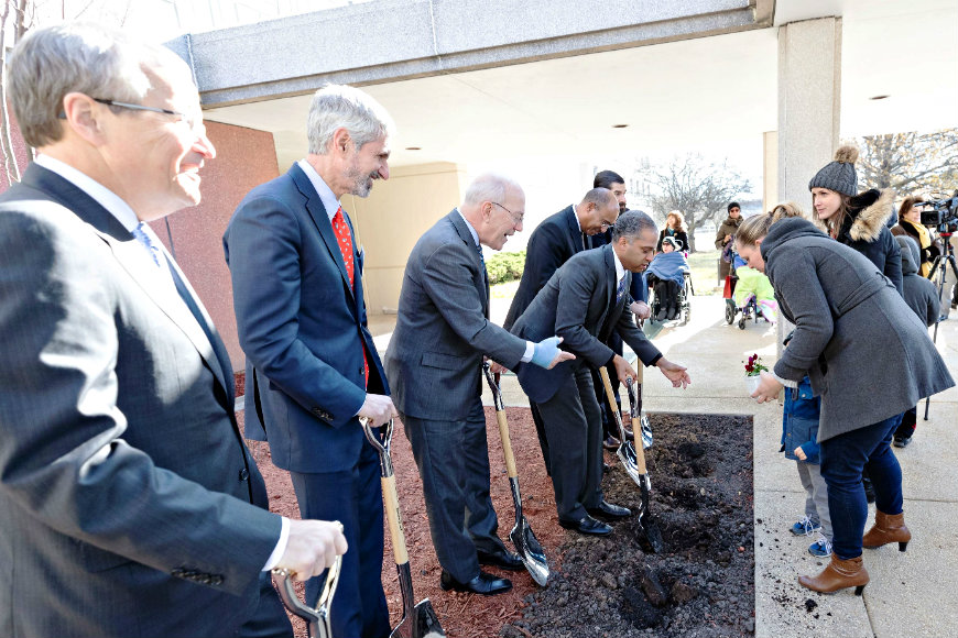 Children and families plant seeds of growth alongside community and hospital leaders at the historic Walter Reed Army Medical Campus.