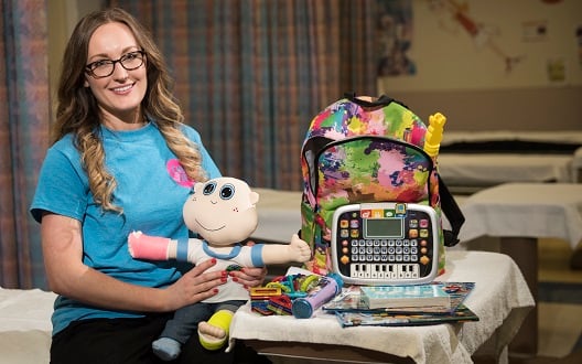Child Life Specialist Liz Johnson next to a cart of activities at Children's National Hospital