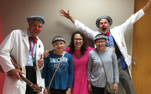 The Clown Care team at Children's National Hospital with a doctor and two patients.