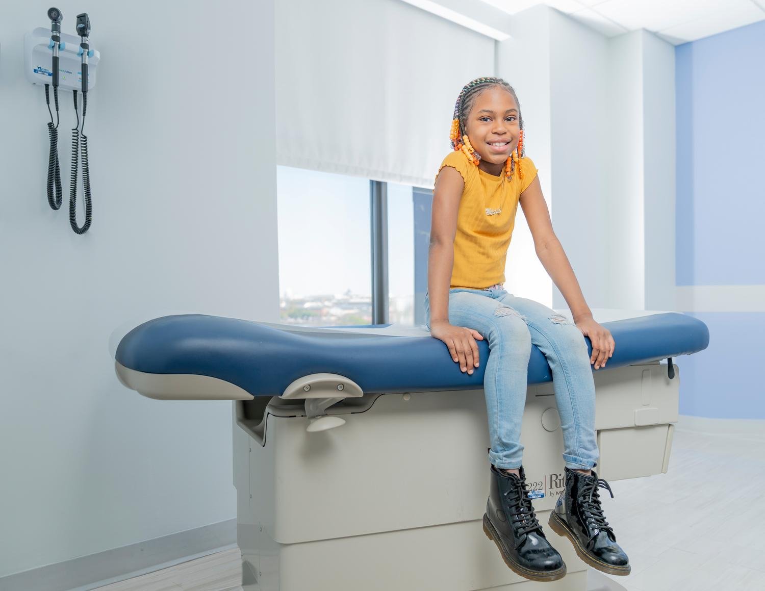 teen girl smiling on exam table