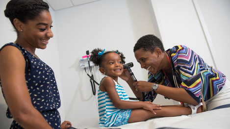 Girl having ears examined at the Anacostia primary care location