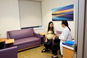 Pregnant woman meets with provider