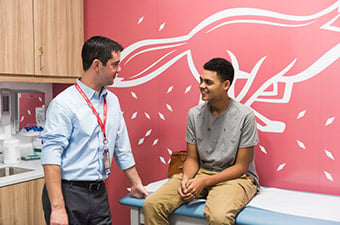 Teen boy with provider in exam room