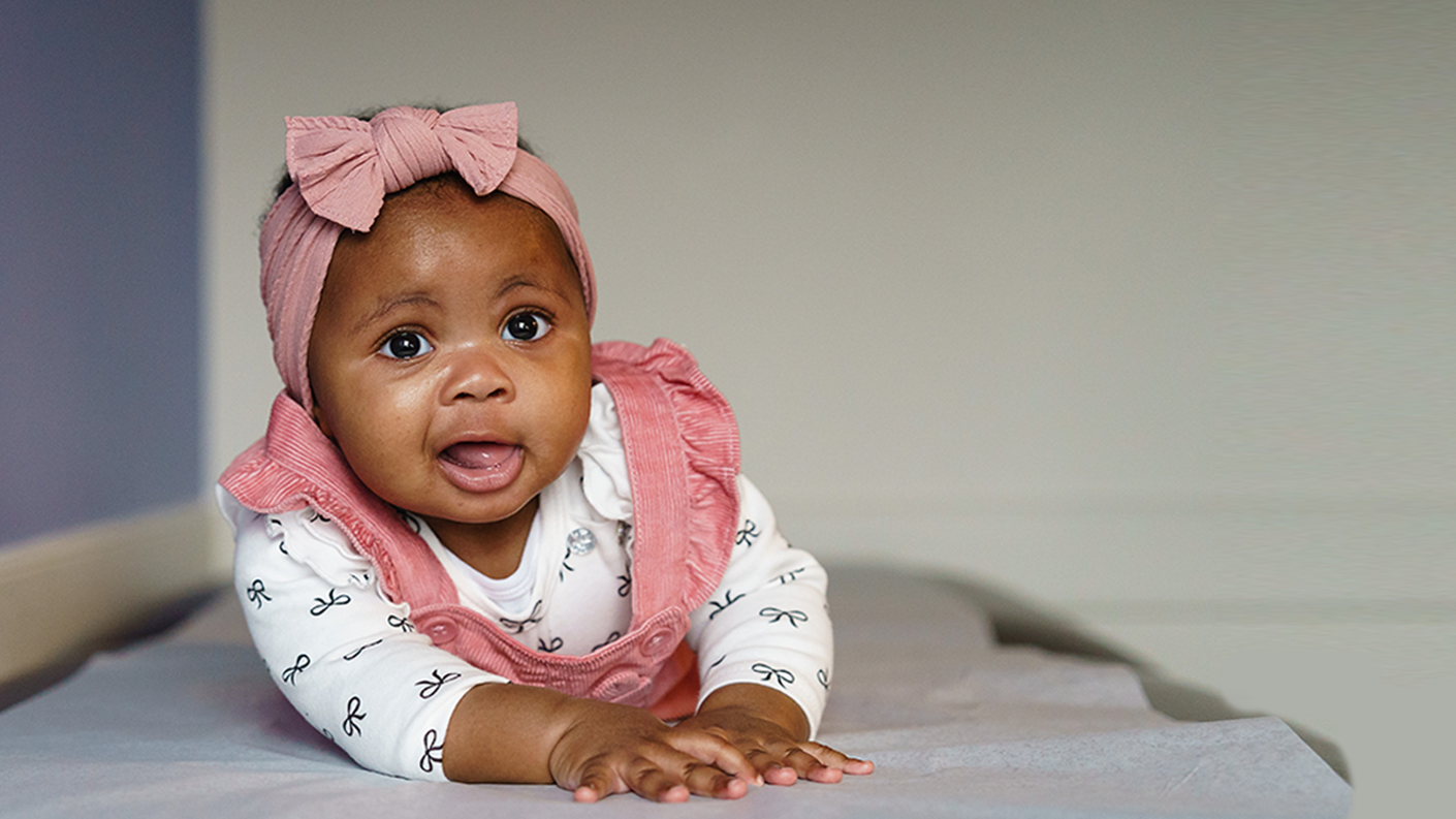 baby girl on exam table at doctor's office
