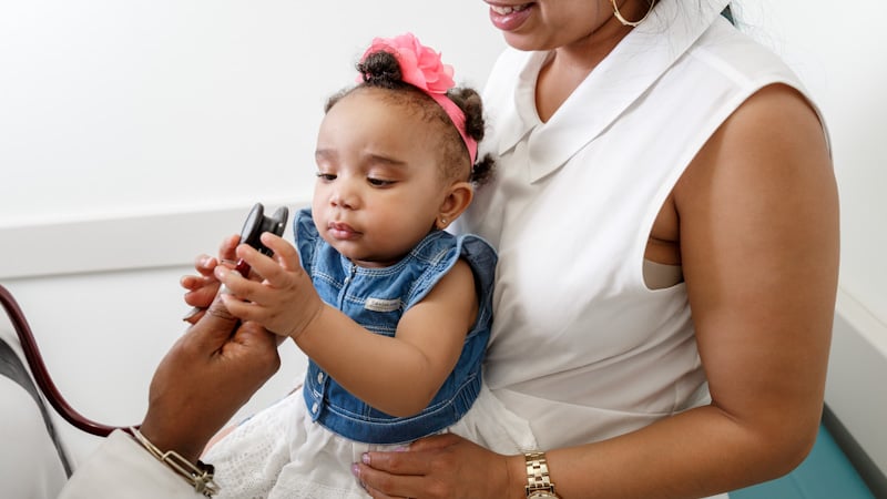 Young girl with Mom at check-up