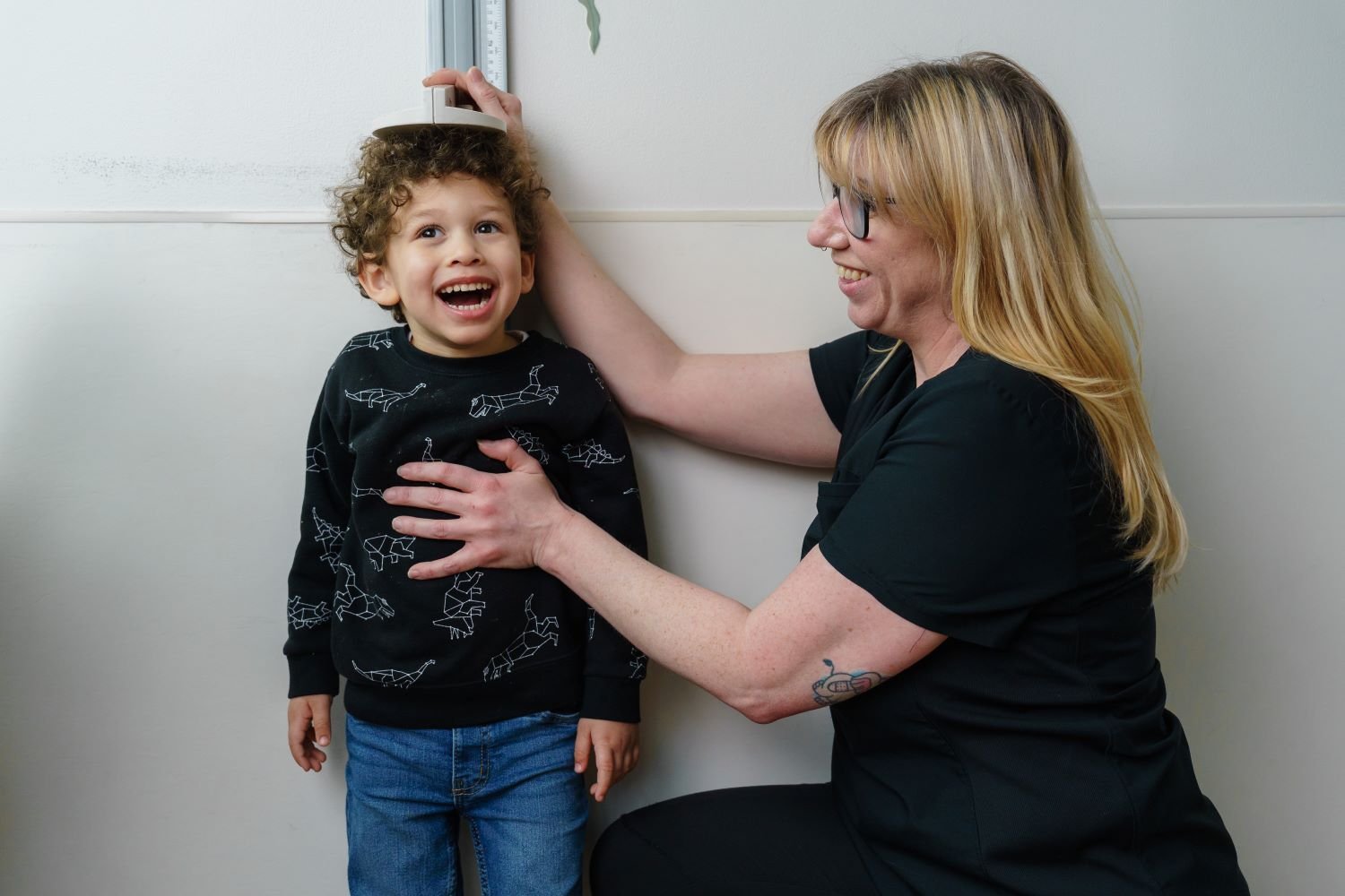provider measures young patient's height 