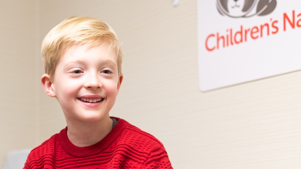 smiling adolescent boy in exam room
