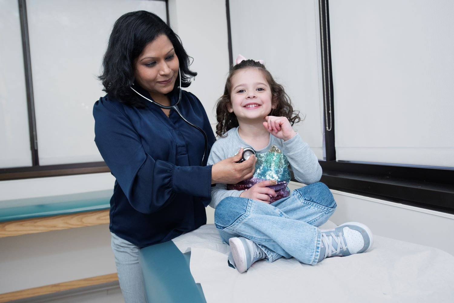doctor examines young female patient