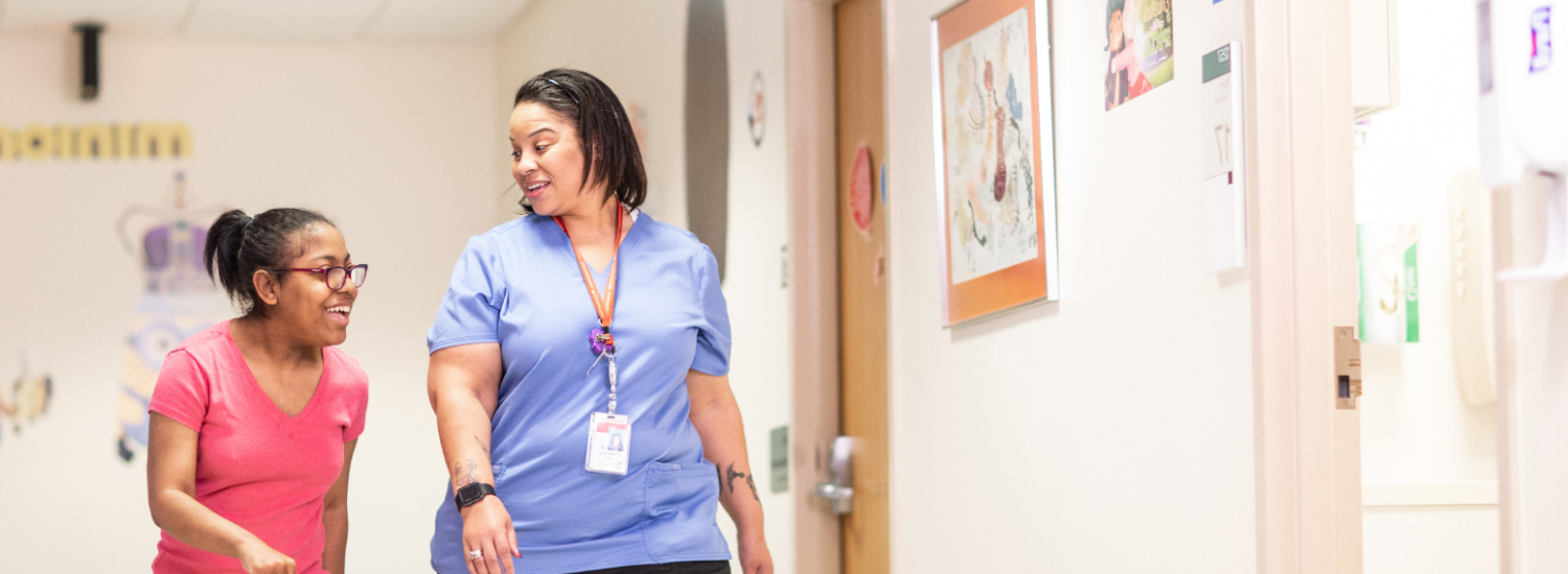 Provider and patient walking down the hallway