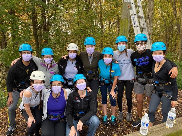 A group of residents wearing blue safety helmets during an outdoor excursion.