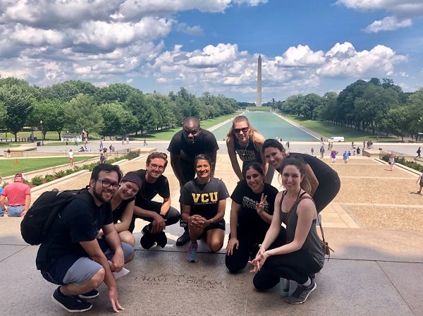 A group of residents on the National Mall with the Washington Monument in the background.