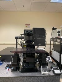 Black microscope unit designed for organotypic imaging, on air table.