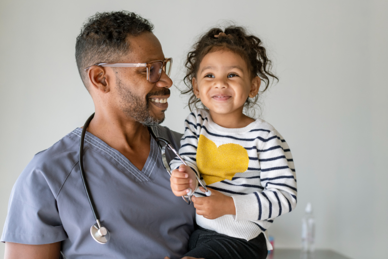 Male nurse holding a little girl