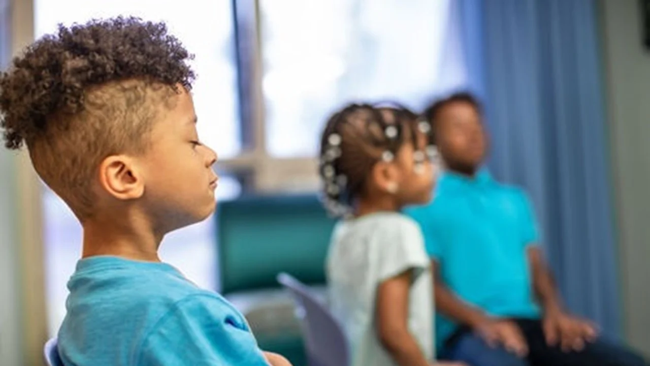 Kids sitting with eyes closed