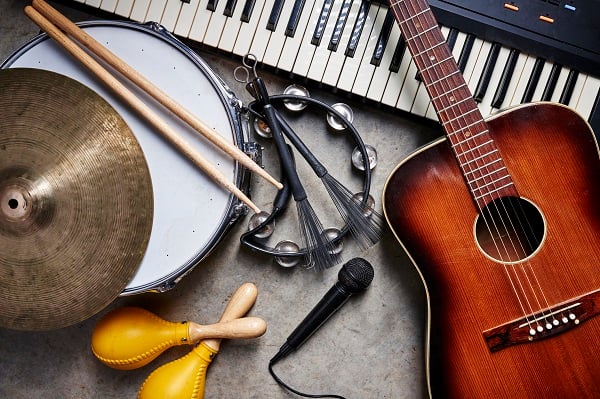 A guitar, drum, tambourine, keyboard, cymbal, maracas and microphone