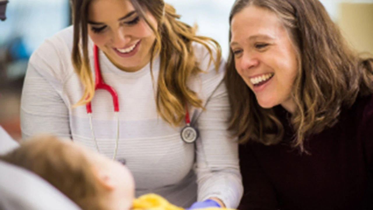 mother and doctor smiling at baby