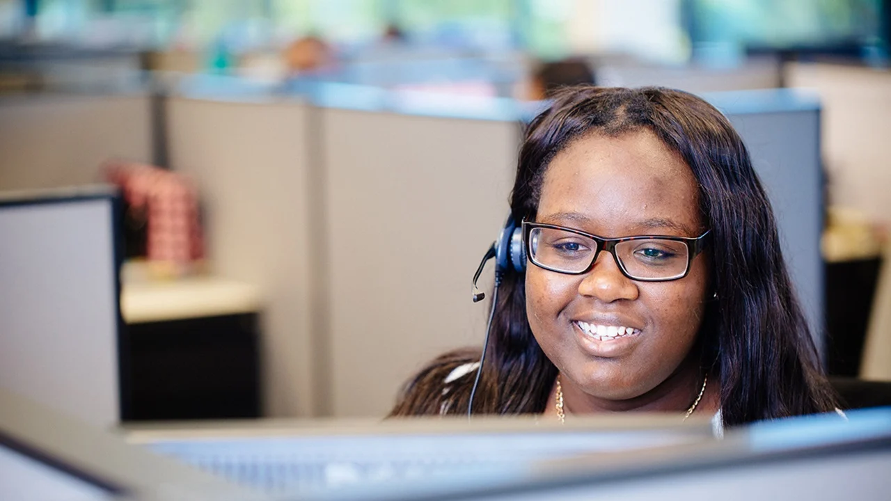 Woman with glasses at a computer