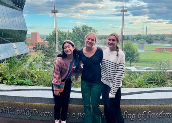 Three teenage girls stand together in the Bunny Mellon Healing Garden at Children's National Hospital.