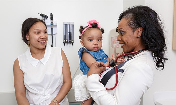 A Doctor holding a baby girl