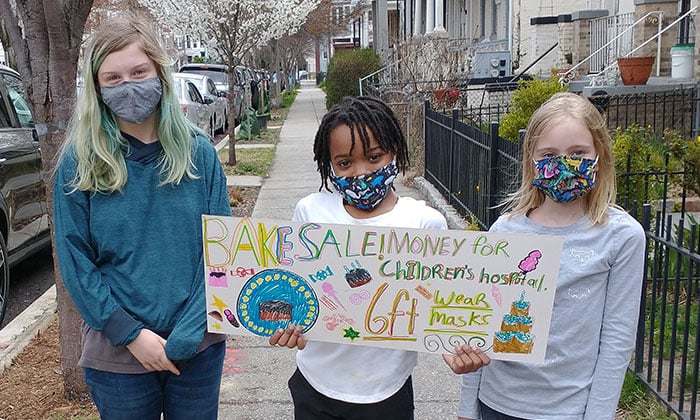 Girls holding a fundraising sign 