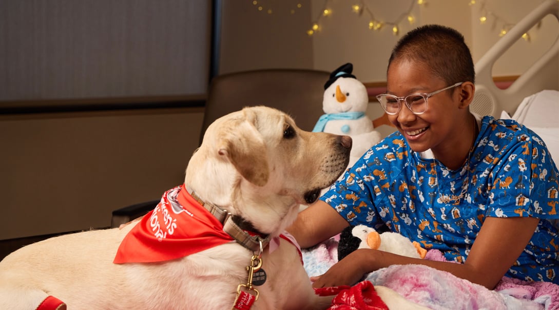 Patient KenLeigh engaging with a therapy dog