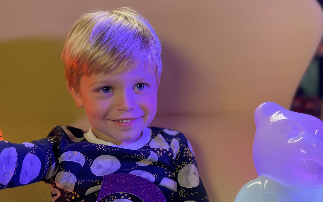 Holden, a Children's National patient, looks in wonder at Light Up Dr. Bear.