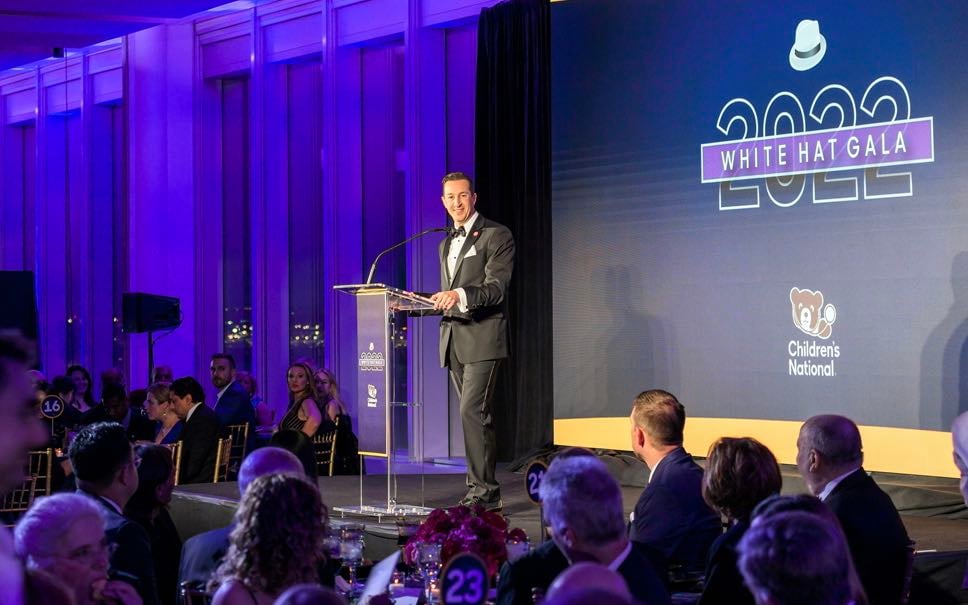 An emcee addresses the audience at the Children's Hospital White Hat Gala.