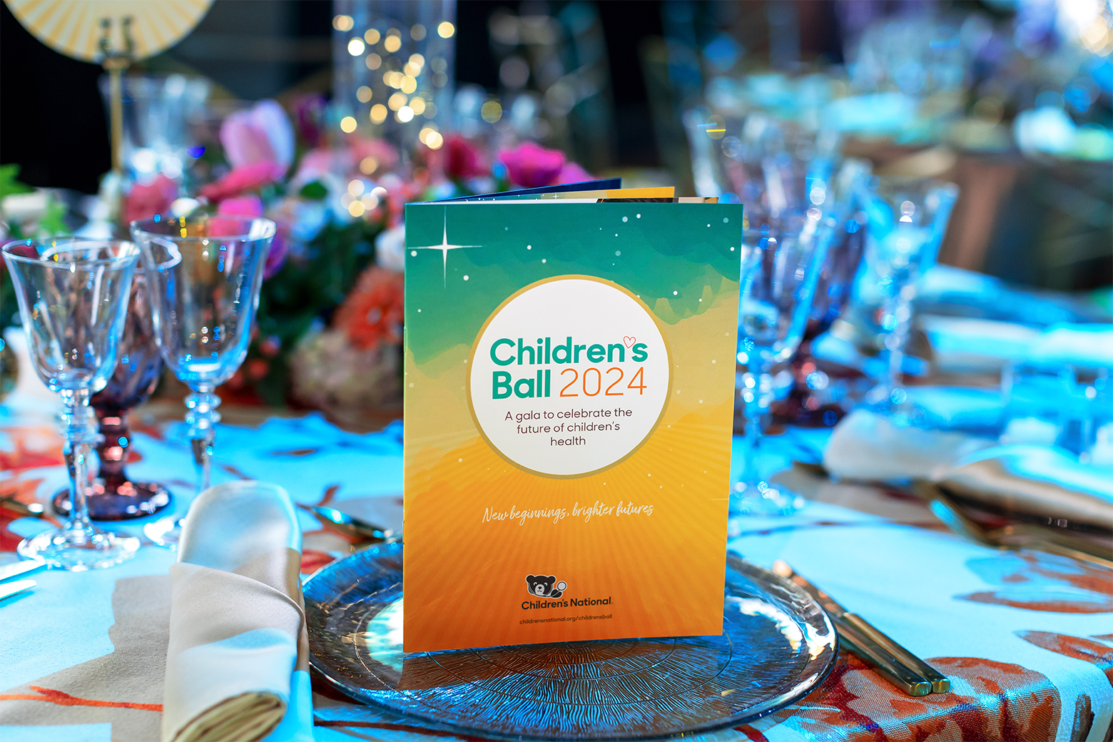 Children's Ball table scape with a itinerary pamphlet. 