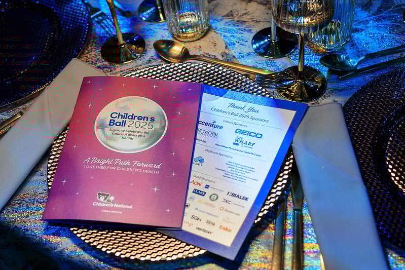 Children's Ball 2025 place setting with printed event information