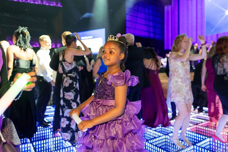 Children's Ball 2025 featured guest and Children's National Hospital patient, Raci, on the dance floor in a purple dress
