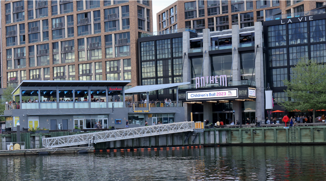 Photo of The Wharf in D.C., a waterfront building featuring a facade filled with windows.