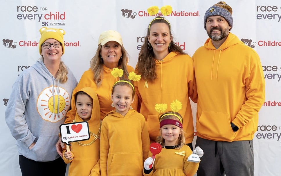 A family of seven poses for a photograph at the Race for Every Child.